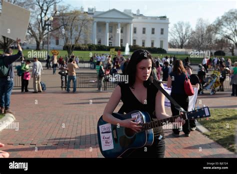 Woman singing folk punk anti war protest songs in front of white house ...