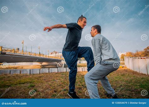 Friends Performing Freestyle Jumping at Urban Place Stock Image - Image ...