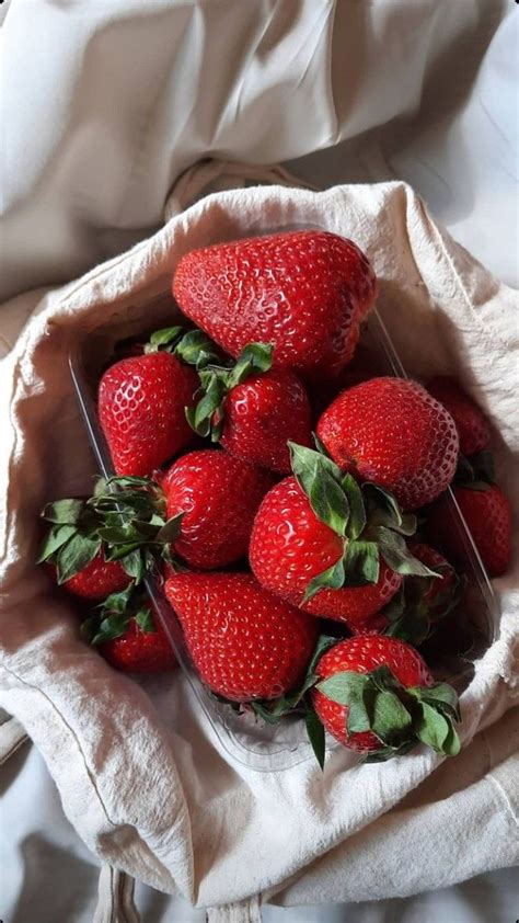 a bunch of strawberries in a plastic container