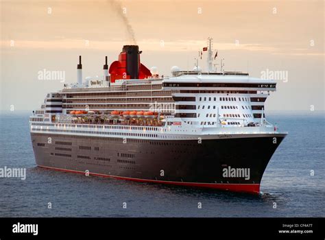 RMS Queen Mary 2, the largest ocean liner ever built, off the port of Monaco at dusk Stock Photo ...
