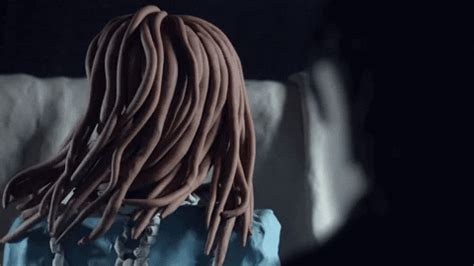 a woman with dreadlocks standing in the dark