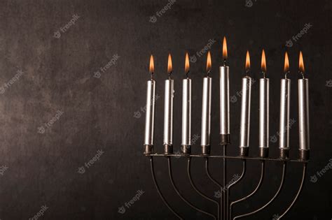 Free Photo | Menorah with candles near gray wall