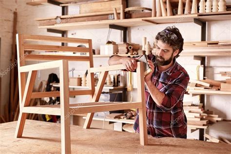 Artisan carefully sanding chair frame — Stock Photo © mavoimages #100907956