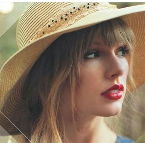 a woman wearing a straw hat with red lipstick on her lips and long ...