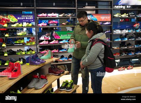 People shop at Adidas outlet in Beijing, China. 21-Jan-2014 Stock Photo ...