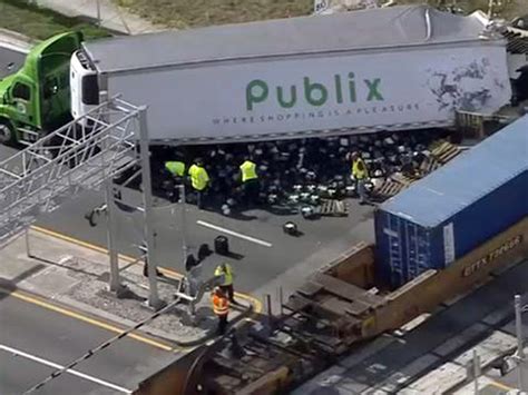 Train hits Publix truck in Deerfield Beach, groceries spilled and road ...