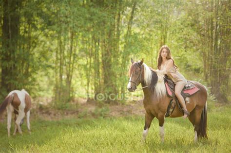 Barefoot woman riding a horse in a meadow, Thailand — stallion ...