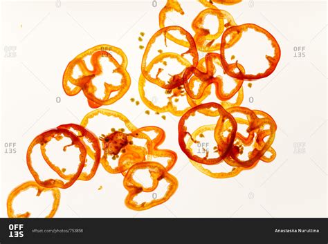 Red and yellow bell pepper slices on backlit background stock photo - OFFSET