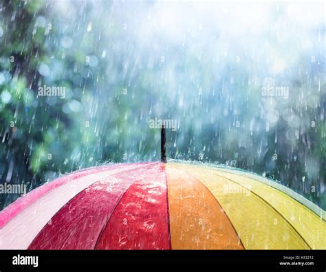 Rain On Rainbow Umbrella Stock Photo - Alamy