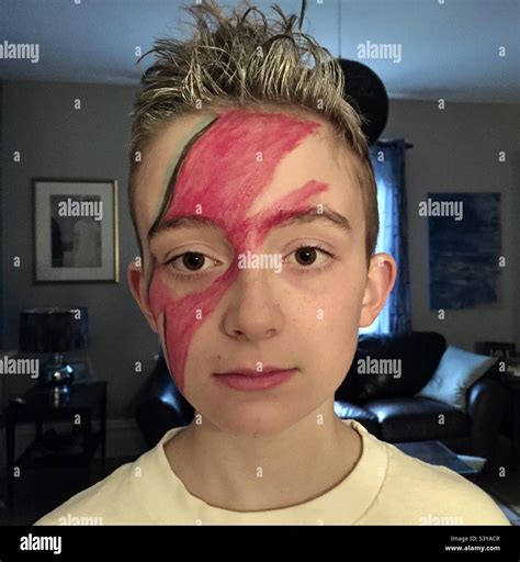 Young boy with the David Bowie Aladdin Sane album cover Lightning bolt makeup Stock Photo - Alamy