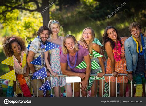 Group of friends standing together in park Stock Photo by ...