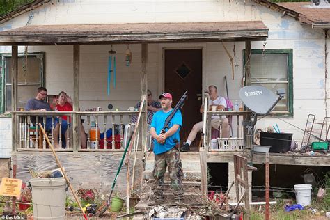 Demonstrators march to entrance of KKK national director Thomas Robb's Arkansas private compound ...