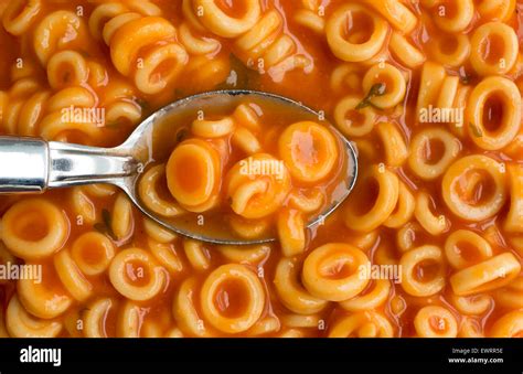 A very close view of canned round spaghetti pasta with tomato sauce in ...