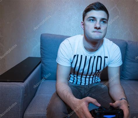 Male gamer playing a video game at home — Stock Photo © Vaicheslav ...