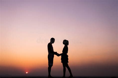 Silhouette of Couple Holding Hand at Sunset Stock Image - Image of couple, relax: 137495247