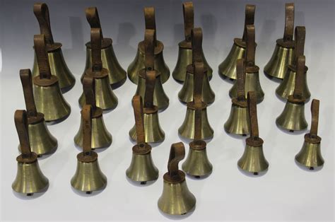 A set of twenty-five 20th century brass musical hand bells, ranging ...