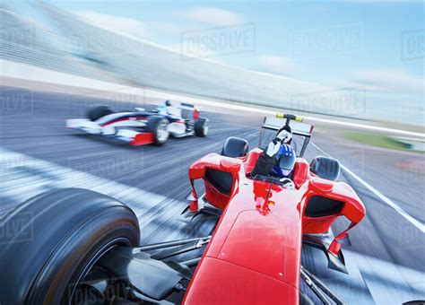 Formula one race car crossing finish line on sports track - Stock Photo - Dissolve