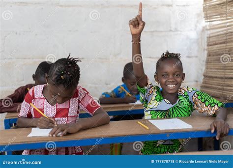 African School Children Raising Their Hands during Lesson Stock Photo ...