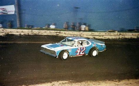 Blue Race Car on a Dirt Track