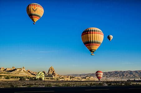 Royalty-Free photo: Red balloons flying under clear blue sky during ...