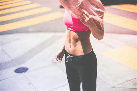 Woman in Pink Sports Bra and Black Leggings Standing on Gray Concrete ...