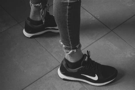 Person Wearing Gray Nike Shoes · Free Stock Photo