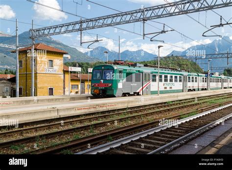 Colico railway station, Lake Como, Italy, with Trenord train and mountains in the distance Stock ...