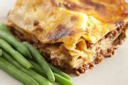 Free Image of Baked Lasagna Served with Green Beans on Plate | Freebie.Photography