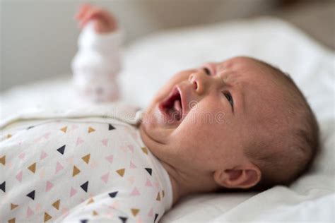 Newborn baby crying on bed stock image. Image of emotion - 175064783