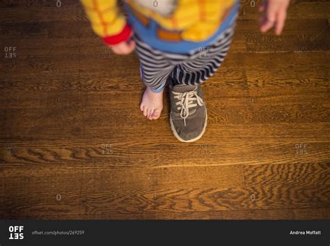 Little boy wearing one shoe stock photo - OFFSET