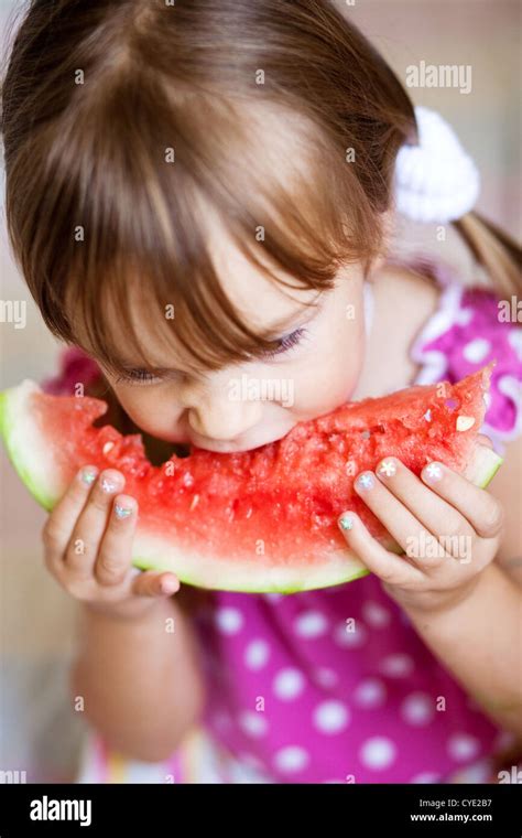 Funny child eating watermelon Stock Photo - Alamy