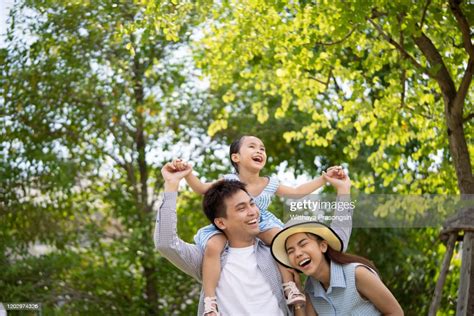 Portrait Of Happy Family In Garden Of Their Home High-Res Stock Photo ...