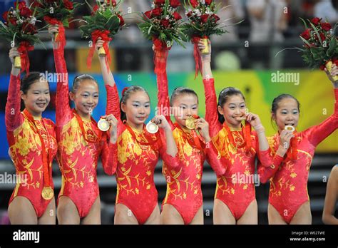 The Chinese women's gymnastics team shows their gold medals on the awards podium for the Women's ...