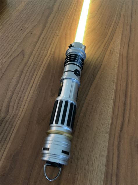 My Peace & Justice lightsaber with yellow kyber crystal : r/GalaxysEdge