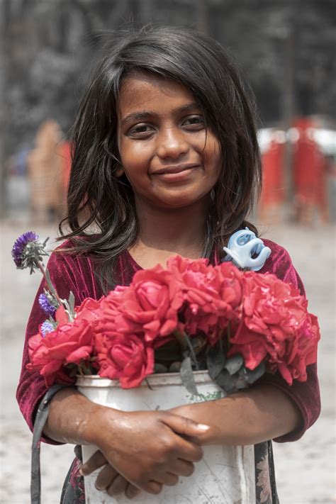 Woman in red floral dress holding pink flower bouquet photo – Free Bangladesh Image on Unsplash