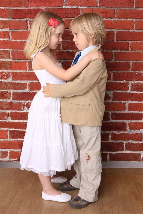 Little Boy Hugging A Beautiful Girl Stock Photo - Image: 15696412