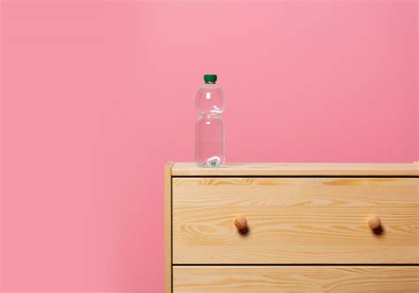 Premium Photo | Bottle with water on wooden bedside table