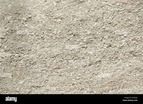 background of sandy limestone in sunlight with small and big stones ...