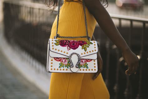 Person Carrying White and Red Floral Leather Crossbody Bag · Free Stock Photo