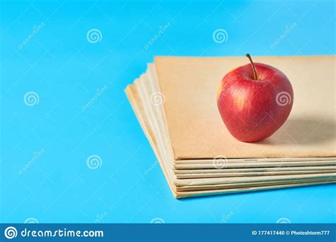 Heap of Blank Magazines, Newspapers or Some Documents and Red Apple on Blue Desk Stock Photo ...