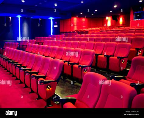 Red seats of cinema hall after the movie Stock Photo - Alamy