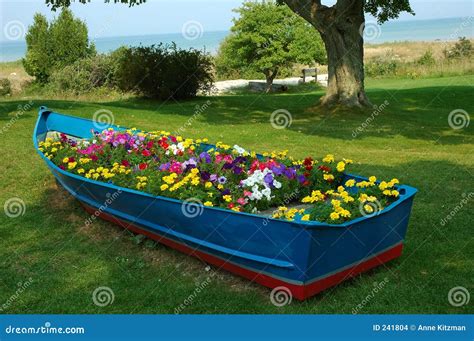 Blue Boat stock photo. Image of garden, water, marigolds - 241804