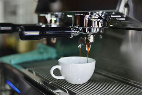 White Ceramic Mug on Espresso Machine Filling With Brown Liquid · Free Stock Photo