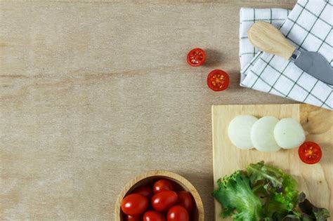 Premium Photo | Top view cooking salad on wood table with copy space.