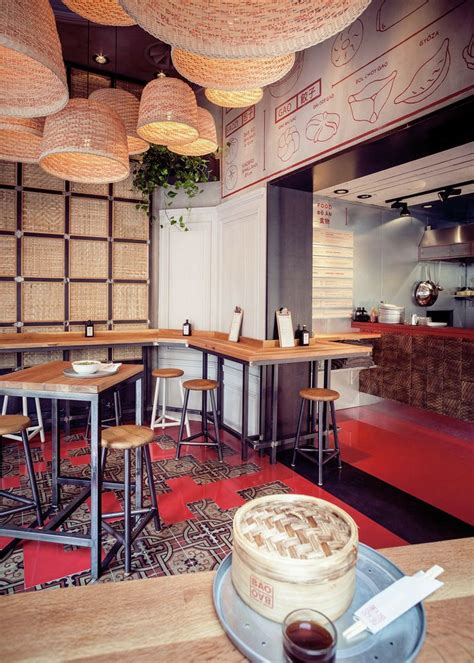 the interior of a restaurant with wooden tables and stools, red ...