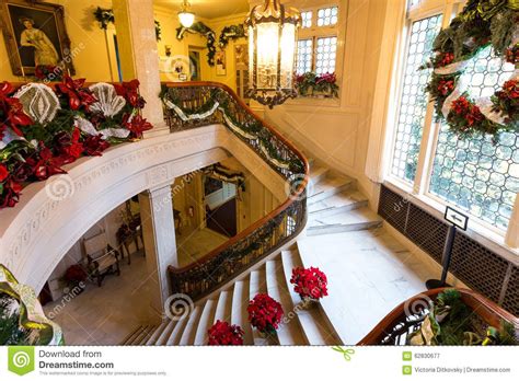 christmas decorations on the stairs and railings in an old style house ...