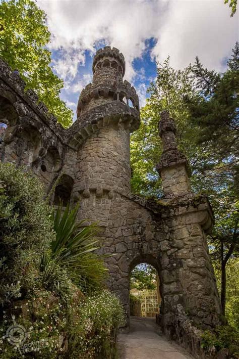 an old stone castle surrounded by greenery and blue skies with clouds ...