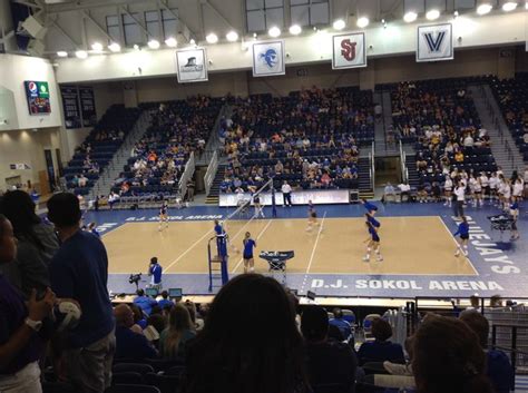 people are playing volleyball in an indoor arena