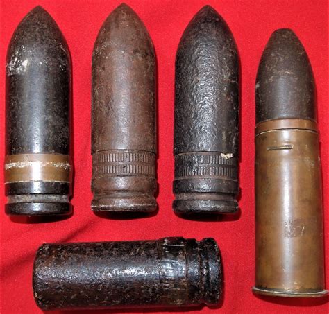 WW1 era artillery ammunition & shells (5). Includes projectiles, dug type and one in brass shell