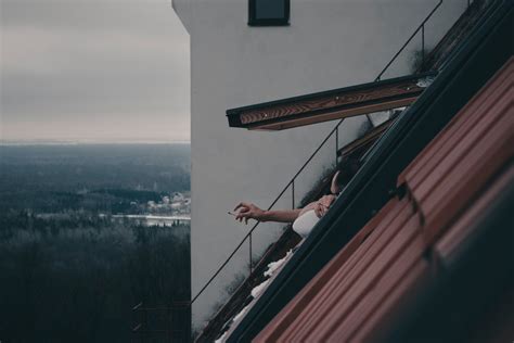 Man Smoking Cigarette in Roof Window · Free Stock Photo